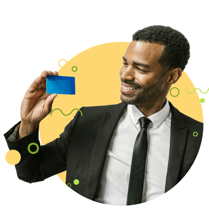 A man holding up a credit card and smiling