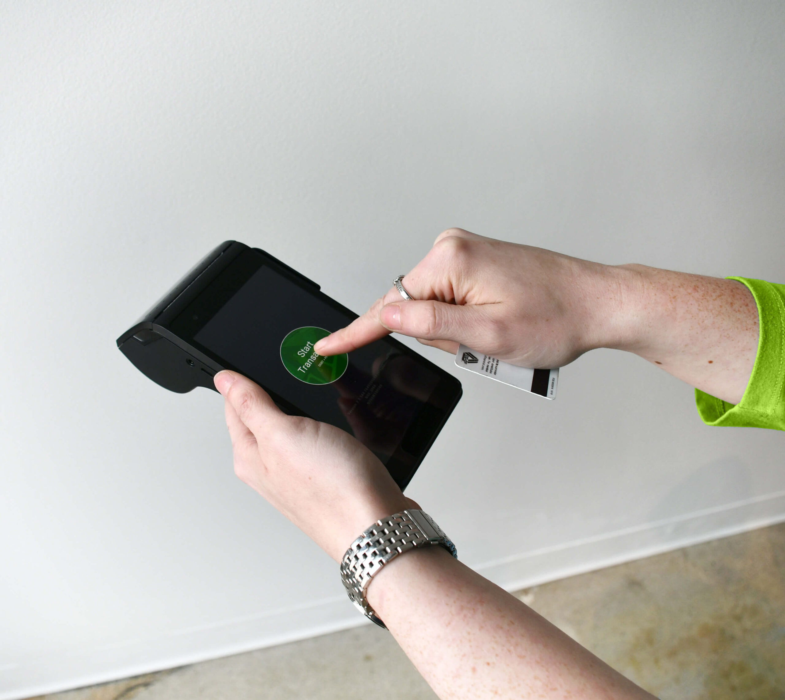 A woman using the ThirdPhase Processor cannabis payment equipment
